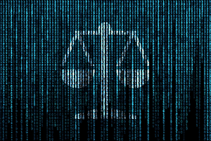 Computer screen covered in binary digits containing an image of a balanced scale used to represent justice.